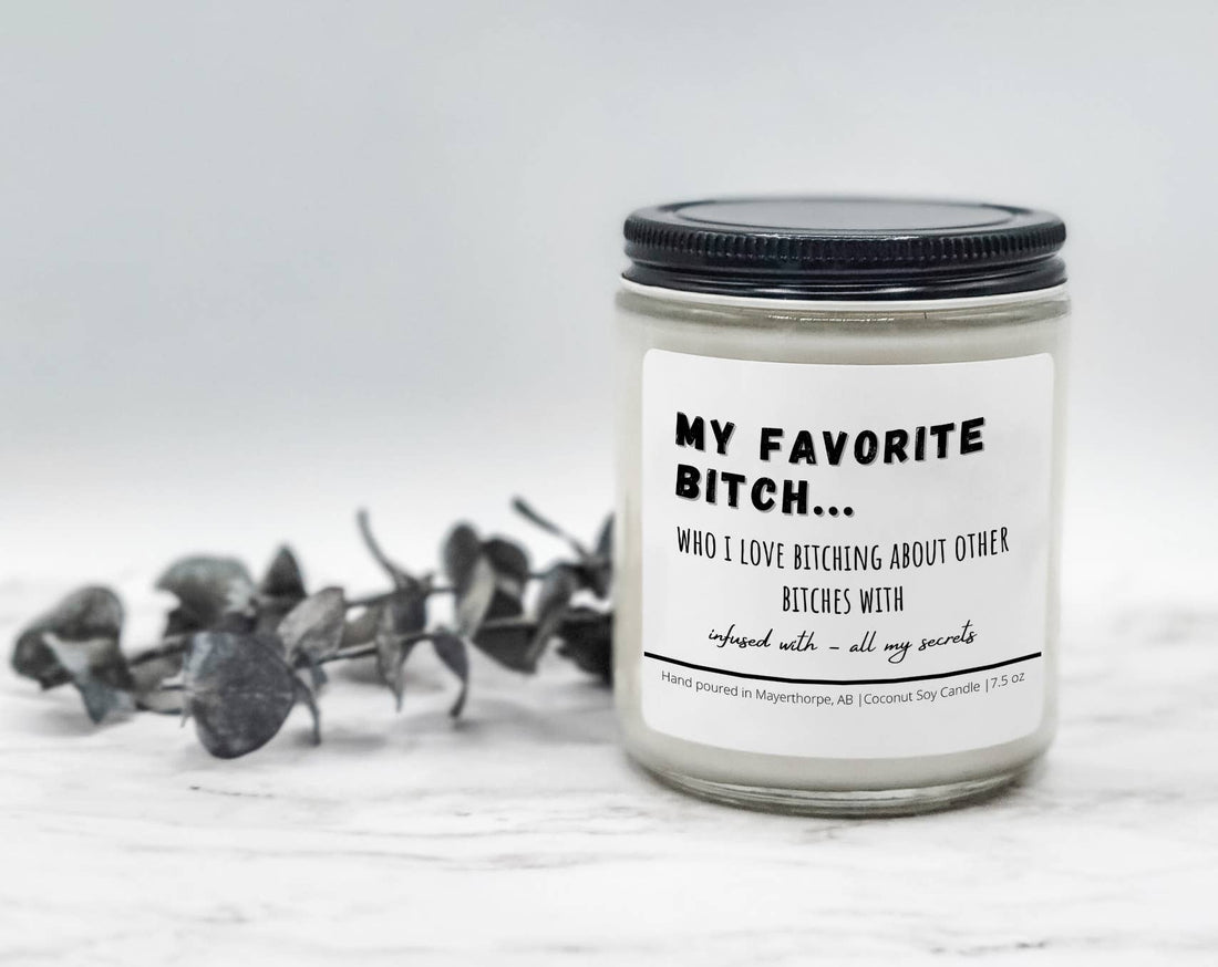 My Favorite Bitch novelty soy candle with a black lid beside eucalyptus