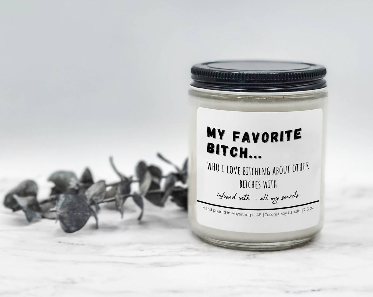My Favorite Bitch novelty soy candle with a black lid beside eucalyptus