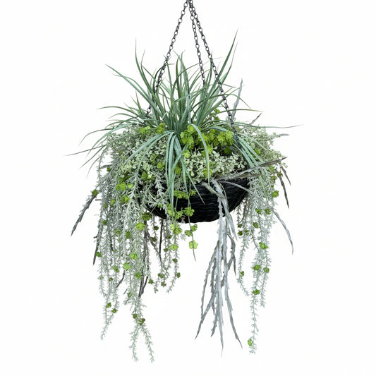 Decorative plant arrangement in a pot against a stone wall.