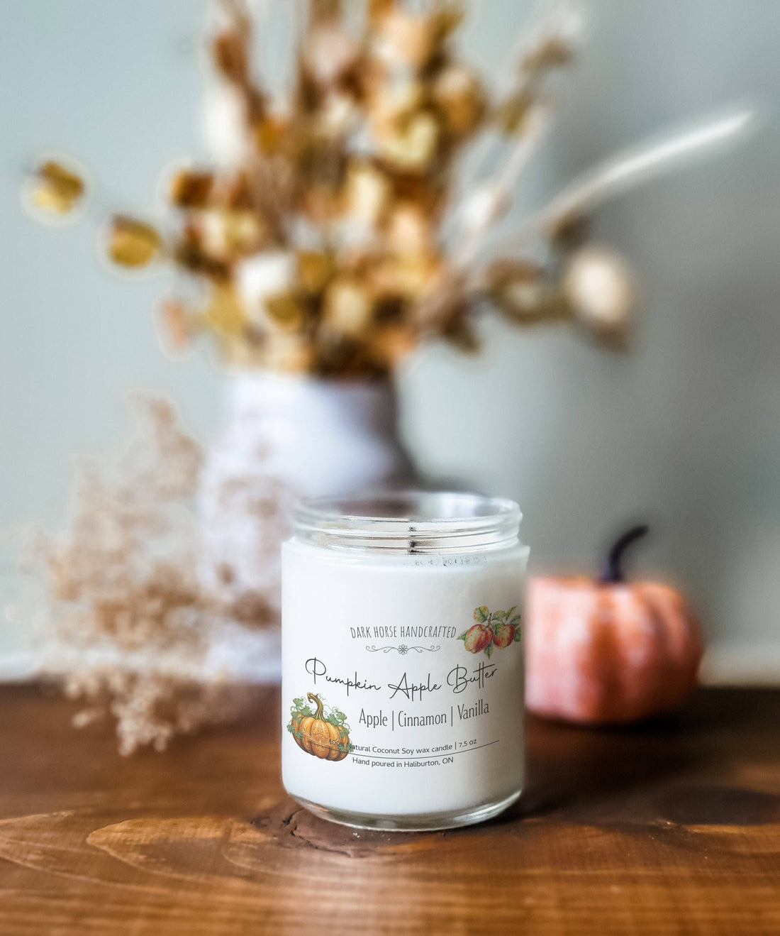 Pumpkin Apple Butter wood wick candle surrounded by fresh apples and pumpkins