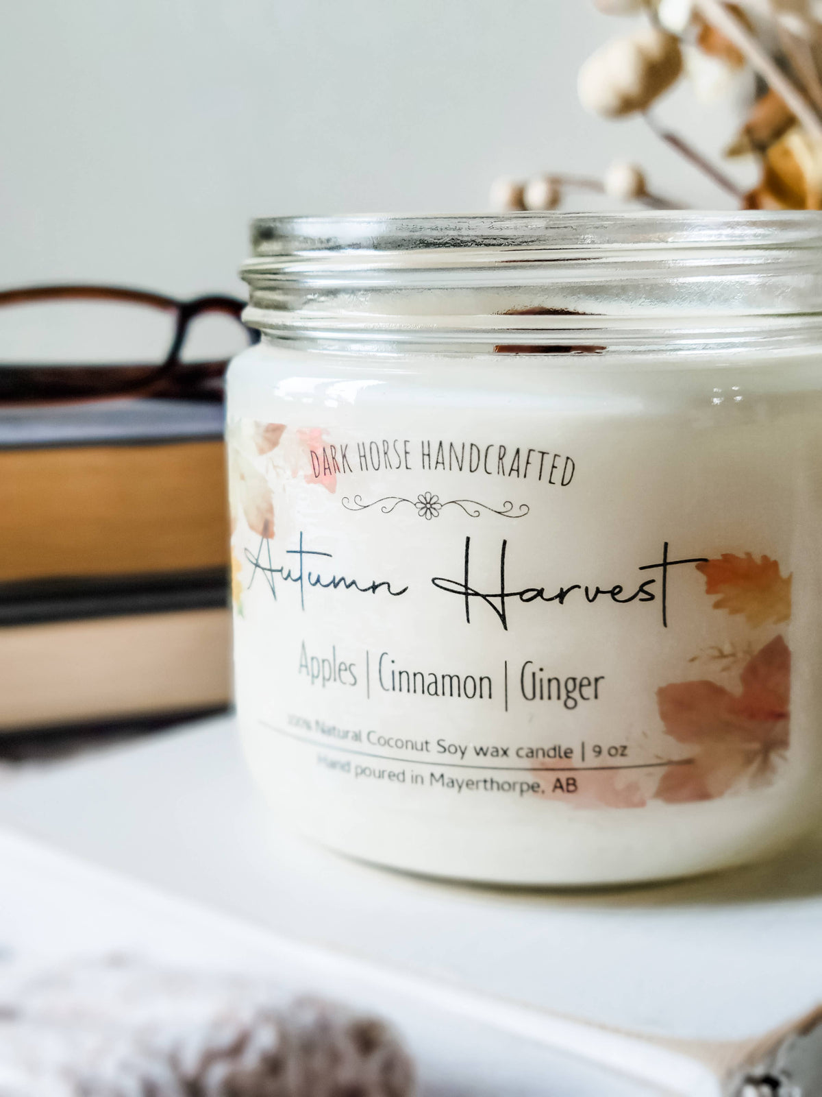 Autumn Harvest soy candle with apple, cinnamon and ginger scent notes on the label
