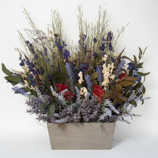 Bouquet of dried flowers in a decorative box on a white shelf