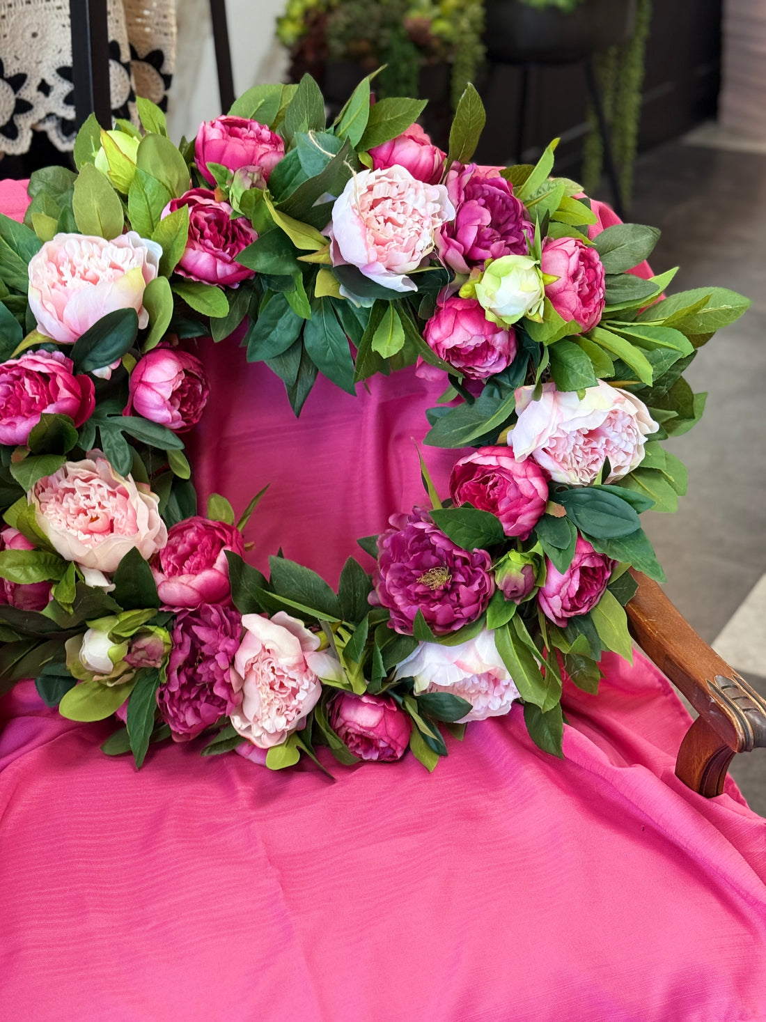 Floral wreath with pink and purple flowers on a white door