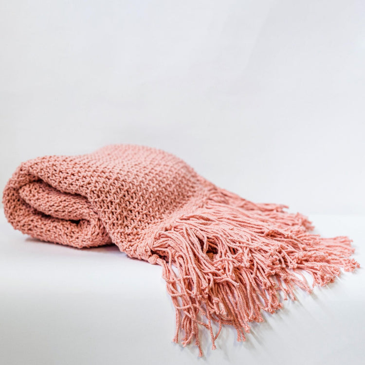 Pink knit blanket with tassels